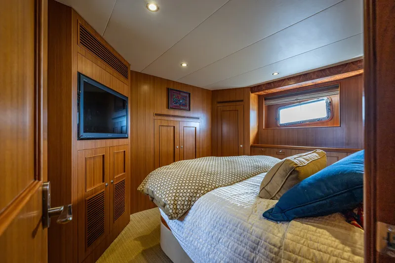 Slide: The Image of Luxurious cabin interior of 2011 Ocean Alexander 60 Trawler with wood paneling and cozy bedding. - 97