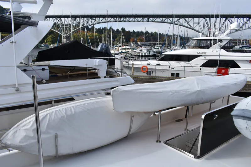 Slide: The Image of 2011 Ocean Alexander 60 Trawler docked, with covered equipment and marina view. - 43