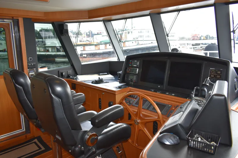 Slide: The Image of Interior helm of 2011 Ocean Alexander 60 Trawler with navigation equipment and leather seating. - 62