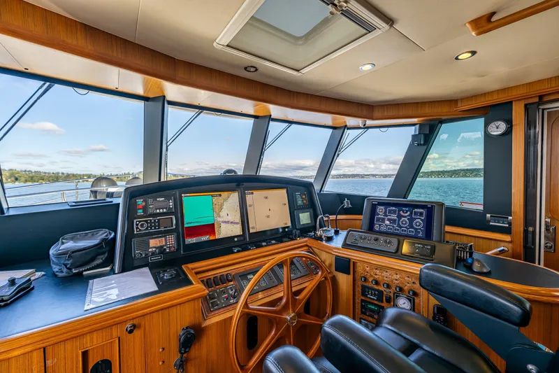 Slide: The Image of Luxurious 2011 Ocean Alexander 60 Trawler helm with advanced navigation systems and panoramic views. - 65