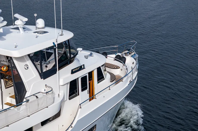 Slide: The Image of 2011 Ocean Alexander 60 Trawler cruising on open water, showcasing sleek design and spacious deck. - 32