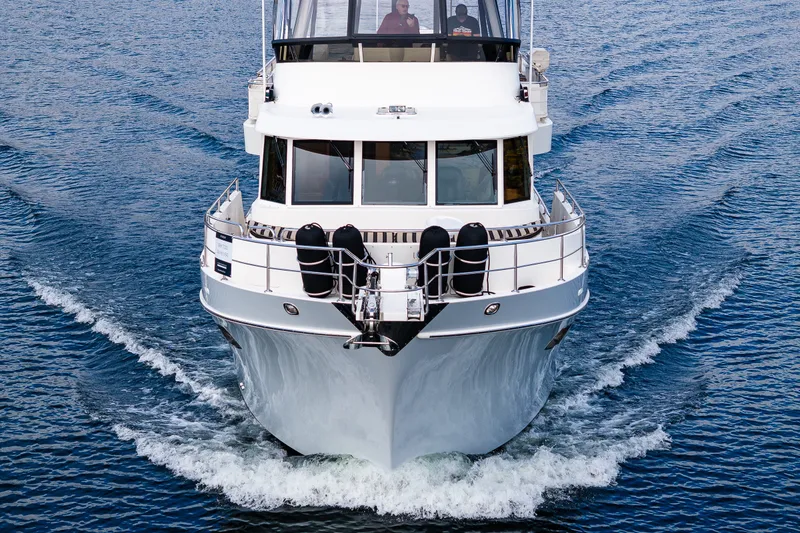 Slide: The Image of Front view of 2011 Ocean Alexander 60 Trawler cruising on water. - 21