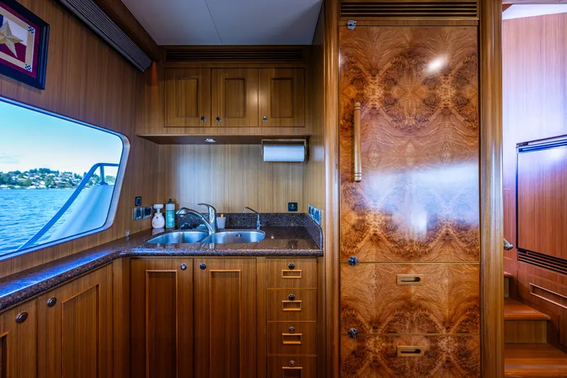Slide: The Image of Luxurious wooden kitchen interior of 2011 Ocean Alexander 60 Trawler yacht with scenic window view. - 81