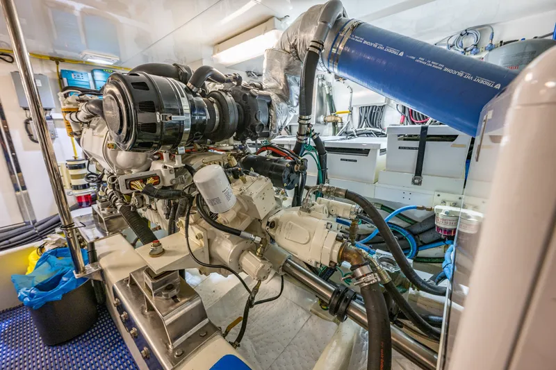 Slide: The Image of Engine room of a 2011 Ocean Alexander 60 Trawler, showcasing detailed machinery and components. - 119