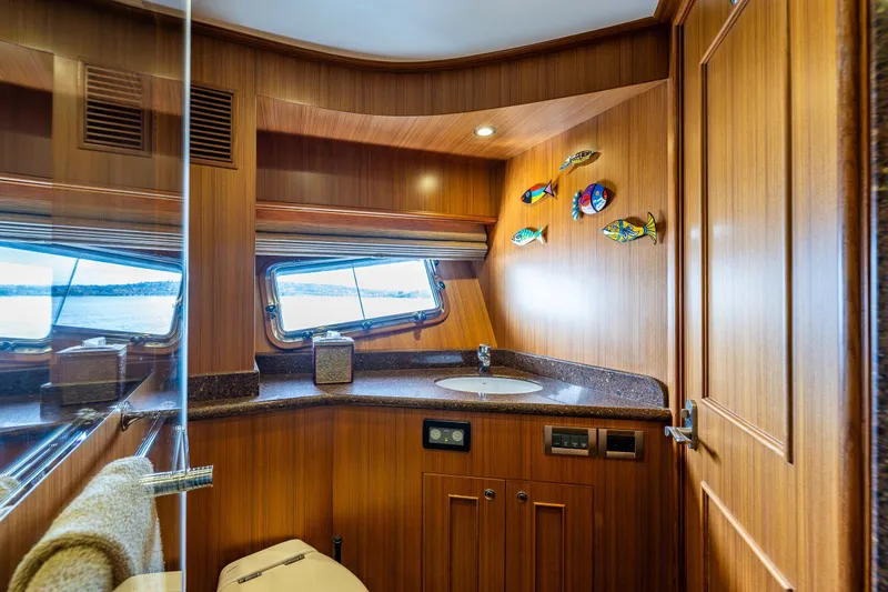 Slide: The Image of Luxurious 2011 Ocean Alexander 60 Trawler bathroom with wooden interior and ocean view. - 89