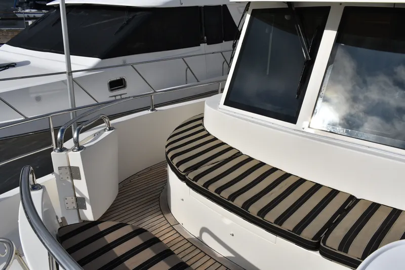 Slide: The Image of 2011 Ocean Alexander 60 Trawler with striped seating and sleek design. - 34