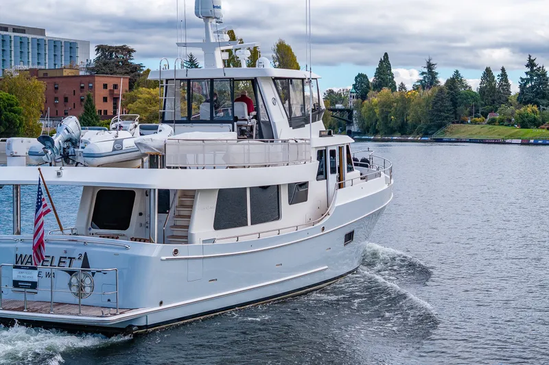 Slide: The Image of 2011 Ocean Alexander 60 Trawler cruising on a scenic river with lush greenery. - 15