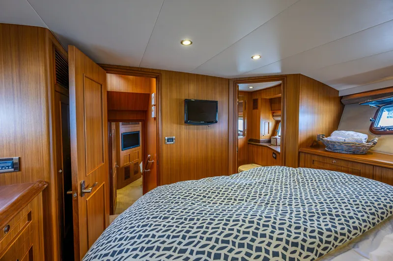 Slide: The Image of Luxurious cabin interior of 2011 Ocean Alexander 60 Trawler with wood paneling and cozy bedding. - 93