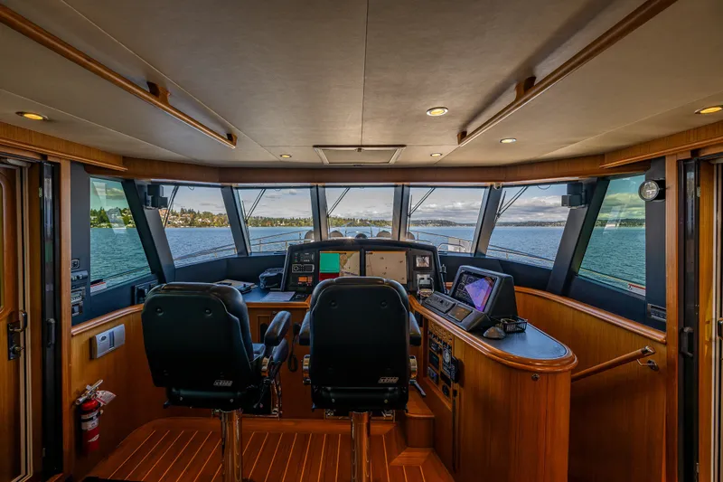 Slide: The Image of Pilothouse interior of 2011 Ocean Alexander 60 Trawler with panoramic windows and navigation equipment. - 67