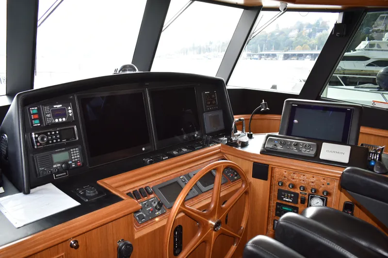 Slide: The Image of Cockpit of 2011 Ocean Alexander 60 Trawler with navigation equipment and wooden steering wheel. - 61