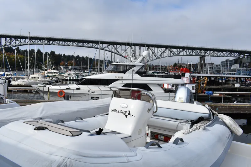 Slide: The Image of Docked Ocean Alexander 60 Trawler yacht, 2011 model, with marina and bridge in background. - 44