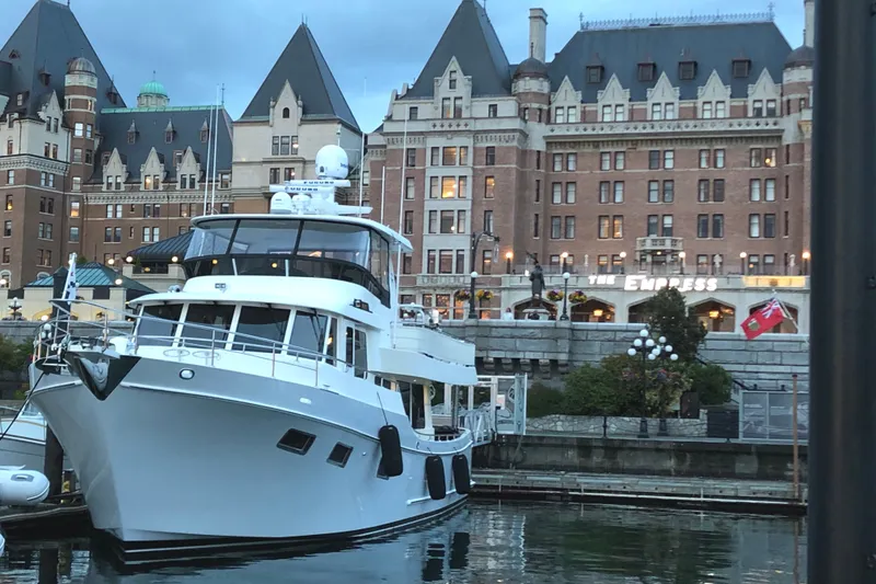 Slide: The Image of Ocean Alexander 60 Trawler 2011 docked near historic building, evening view. - 6