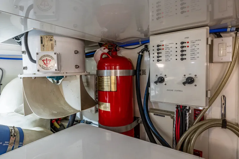 Slide: The Image of Engine room of 2011 Ocean Alexander 60 Trawler with control panel and fire extinguisher. - 117