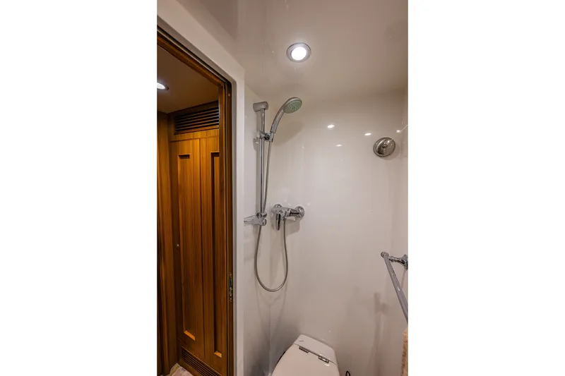 Slide: The Image of Shower area in 2011 Ocean Alexander 60 Trawler with wooden door and modern fixtures. - 103