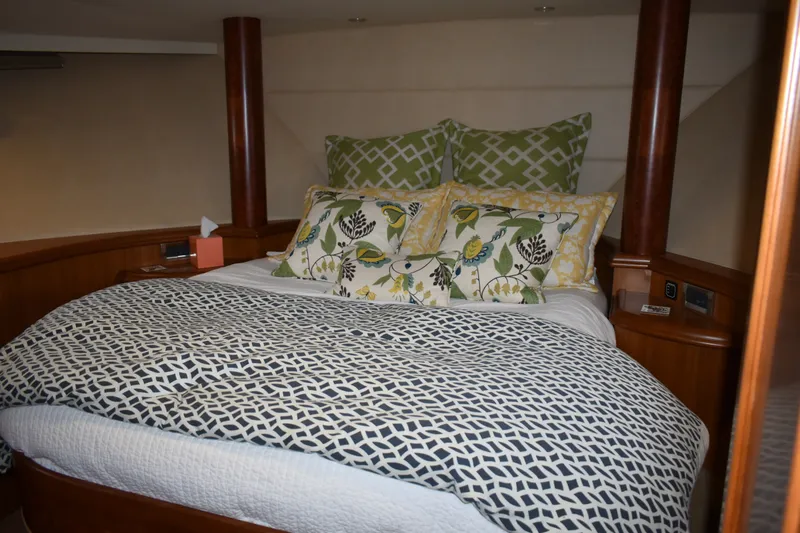 Slide: The Image of Luxurious bedroom interior of 2011 Ocean Alexander 60 Trawler with patterned bedding and pillows. - 92