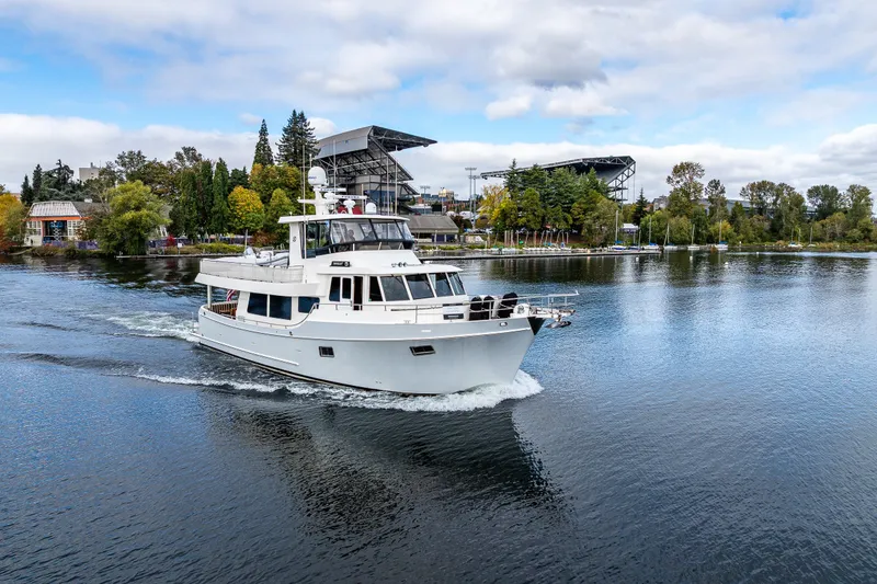 Slide: The Image of Ocean Alexander 60 Trawler 2011 cruising on a scenic waterway with trees and buildings. - 22