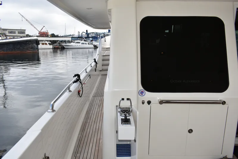 Slide: The Image of 2011 Ocean Alexander 60 Trawler docked, showcasing sleek deck design and marina view. - 38