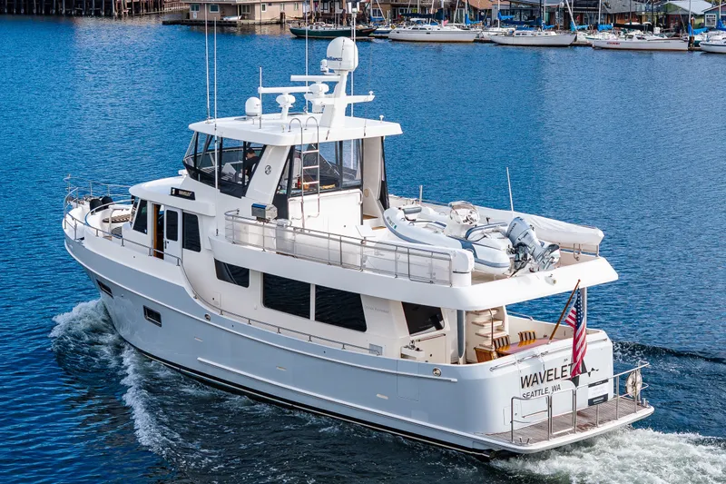 Slide: The Image of Ocean Alexander 60 Trawler 2011 cruising in a marina with American flag displayed. - 28