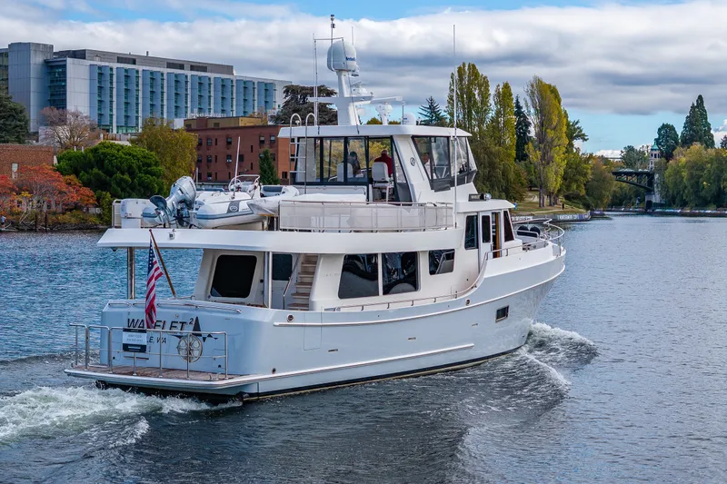 Slide: The Image of Ocean Alexander 60 Trawler 2011 cruising on a scenic river with urban backdrop. - 19