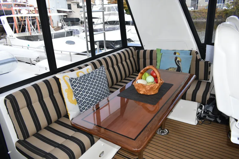 Slide: The Image of Luxurious 2011 Ocean Alexander 60 Trawler interior with striped seating and elegant wooden table. - 52