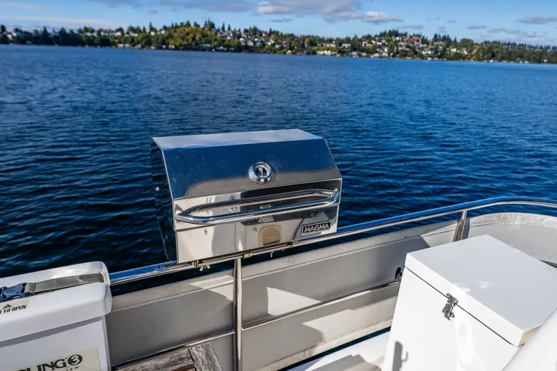 Slide: The Image of Stainless steel grill on 2011 Ocean Alexander 60 Trawler, overlooking serene lake view. - 47