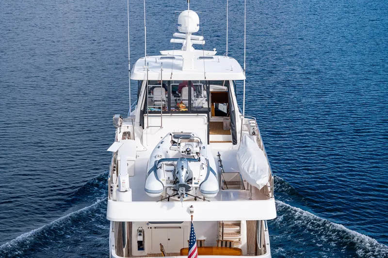 Slide: The Image of Ocean Alexander 60 Trawler 2011 cruising on open water, rear view with dinghy on deck. - 29