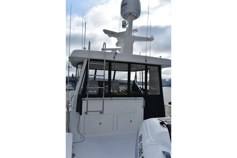 Slide: The Image of 2011 Ocean Alexander 60 Trawler, rear view with radar and seating area. - 49