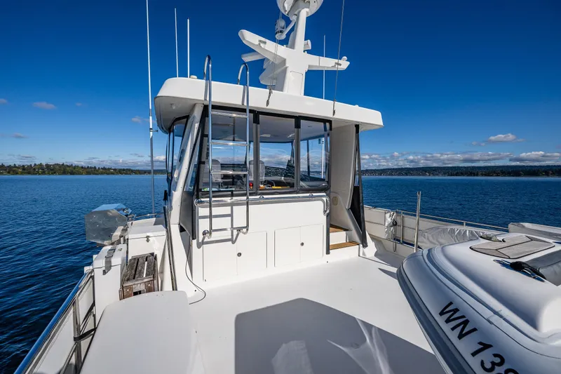Slide: The Image of 2011 Ocean Alexander 60 Trawler on calm water, showcasing deck and cabin. - 50