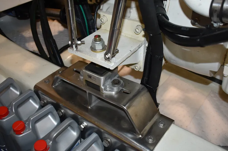 Slide: The Image of Engine compartment of 2011 Ocean Alexander 60 Trawler, featuring mechanical components and oil containers. - 111