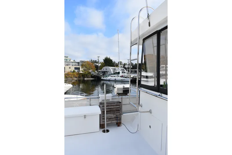 Slide: The Image of 2011 Ocean Alexander 60 Trawler docked, showcasing sleek design and marina view. - 46