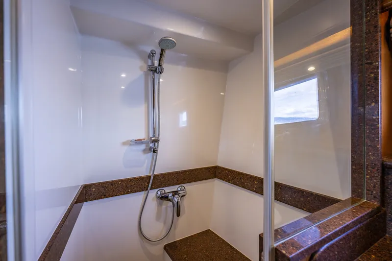 Slide: The Image of Luxurious shower in 2011 Ocean Alexander 60 Trawler yacht with elegant marble accents. - 91