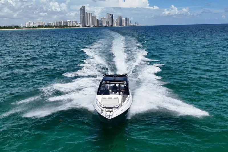 Slide: The Image of Granfort 370 GTX 2027 yacht cruising on blue ocean near city skyline. - 4