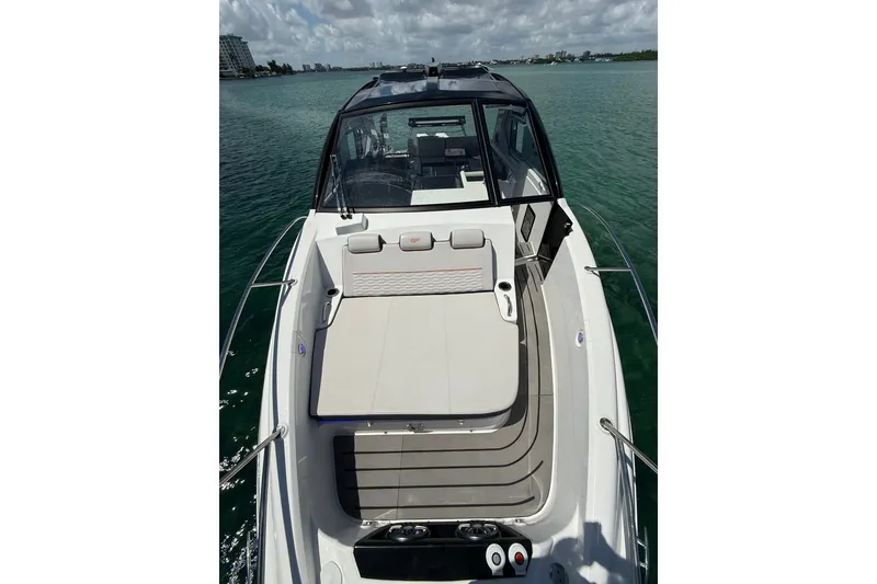Slide: The Image of Granfort 370 GTX 2027 luxury boat on calm water, showcasing sleek design and spacious deck. - 49