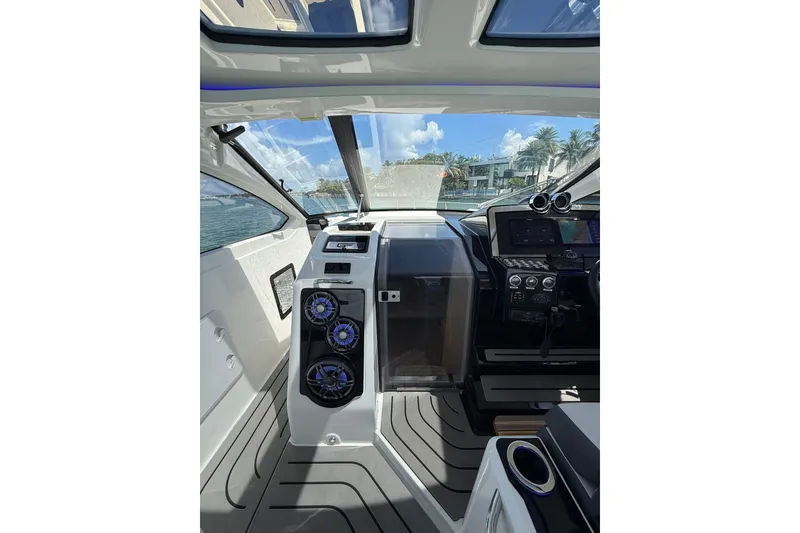 Slide: The Image of Interior view of 2027 Granfort 370 GTX boat cockpit with modern controls and speakers. - 25