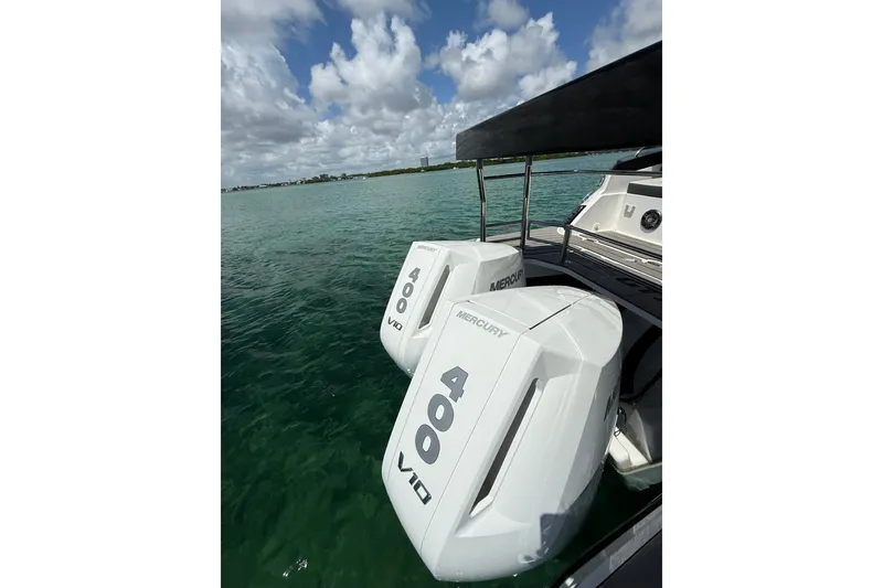 Slide: The Image of Twin Mercury 400 V10 engines on a 2027 Granfort 370 GTX boat, floating on clear water. - 14