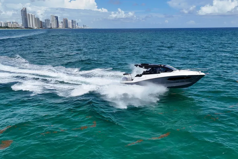 Slide: The Image of Granfort 370 GTX 2027 yacht cruising on vibrant blue ocean near city skyline. - 5