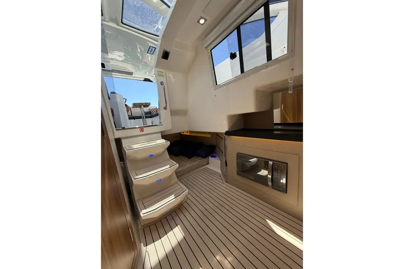 Slide: The Image of Interior of 2027 Granfort 370 GTX yacht, featuring modern design, steps, and sleek cabinetry. - 59