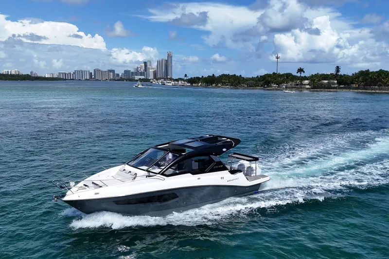 Slide: The Image of 2027 Granfort 370 GTX yacht cruising on blue waters near a city skyline. - 1