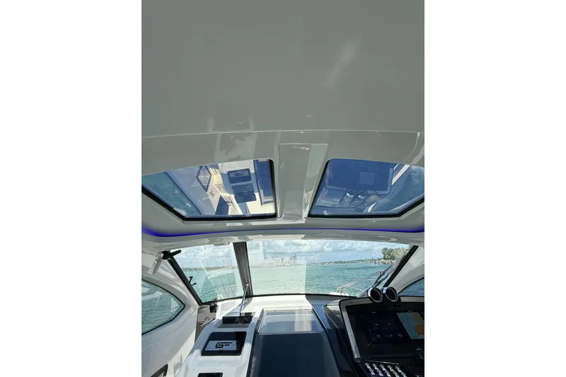 Slide: The Image of Interior view of 2027 Granfort 370 GTX yacht with panoramic sunroof and modern dashboard. - 42