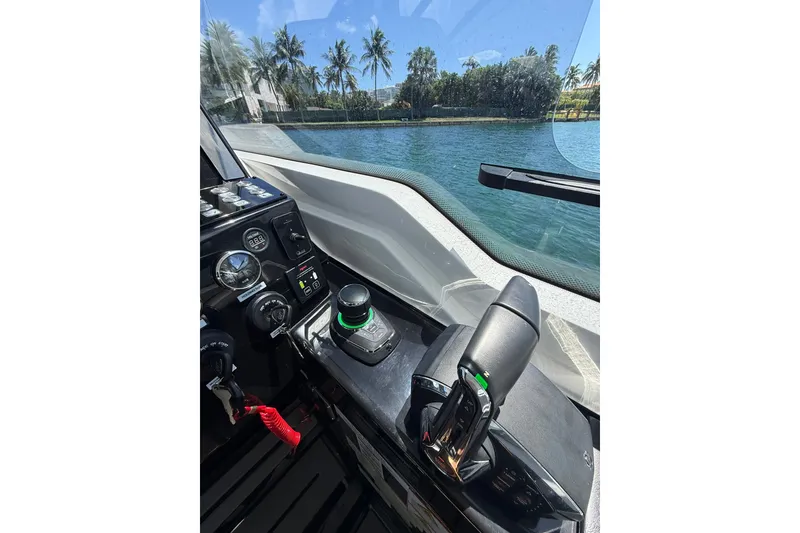 Slide: The Image of Cockpit view of 2027 Granfort 370 GTX boat with control panel and waterway scenery. - 30