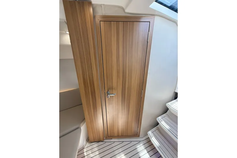 Slide: The Image of Interior of 2027 Granfort 370 GTX yacht featuring sleek wooden door and modern design. - 62