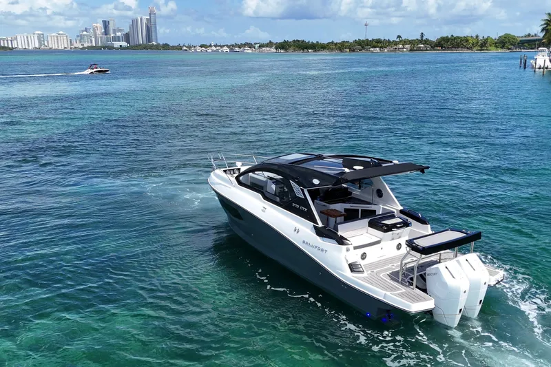 Slide: The Image of Granfort 370 GTX 2027 luxury yacht cruising in clear blue waters near a city skyline. - 11