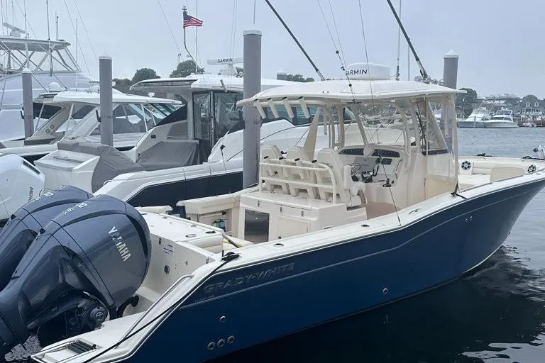 Slide: The Image of 2022 Grady-White Canyon 326 boat docked, featuring dual Yamaha engines. - 13
