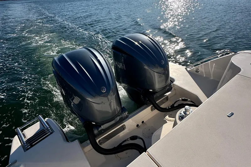 Slide: The Image of 2022 Grady-White Canyon 326 boat with dual outboard engines on water. - 33