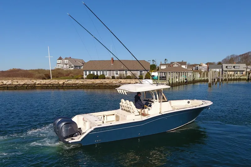 Slide: The Image of 2022 Grady-White Canyon 326 boat cruising near coastal homes and docks. - 4