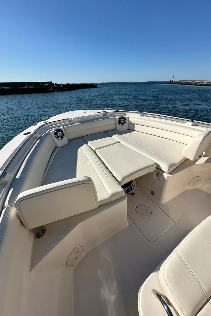 Slide: The Image of 2022 Grady-White Canyon 326 boat with spacious seating, docked by the ocean. - 46
