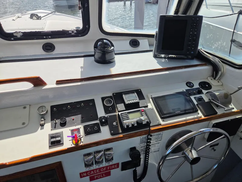 Slide: The Image of The cockpit of a 1998 BHM boat with controls, instruments, and a large screen. - 18