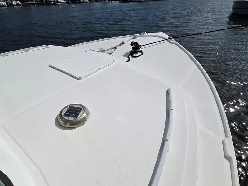 Slide: The Image of The boat features a clean, white deck with a solar panel and an anchor line. - 10