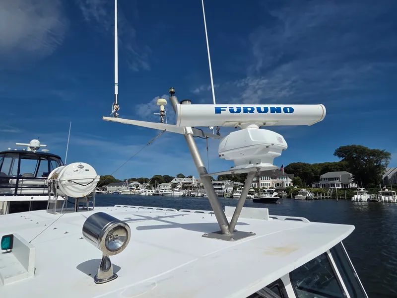 Slide: The Image of A 1998 BHM boat finished by Wilbur Yachts, featuring Furuno radar on the roof. - 9