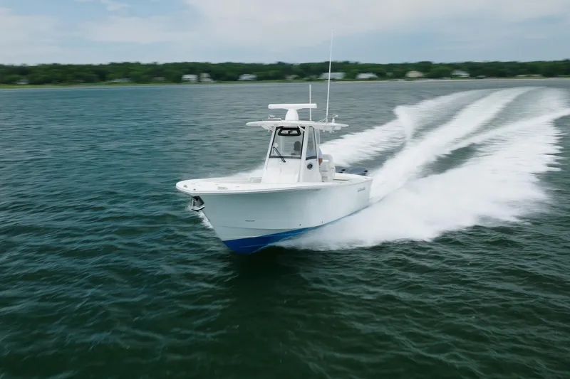 Slide: The Image of 2021 Regulator 28 Forward Seating boat cruising on open water. - 10